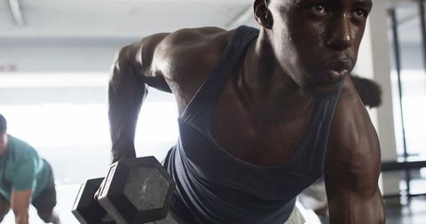 Focused Athlete Lifting Dumbbell in Modern Gym - Download Free Stock Images Pikwizard.com