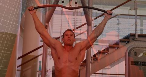 Shirtless athlete performing lat pulldown on curved bar in modern gym for strength training