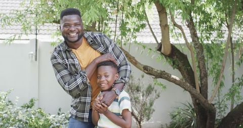 Father and Son Sharing Joyful Moment in Sunny Garden