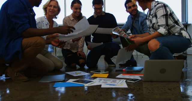 Team Collaboration on Floor with Documents and Gadgets - Download Free Stock Images Pikwizard.com