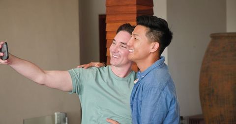 Loving Couple Embracing While Video Chatting on Smartphone