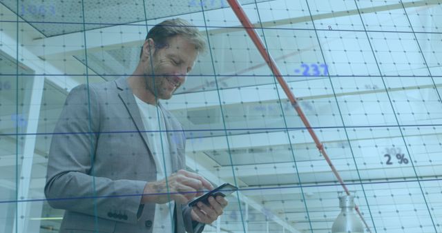 Businessman Analyzing Graphs on Phone in Modern Office Space - Download Free Stock Images Pikwizard.com