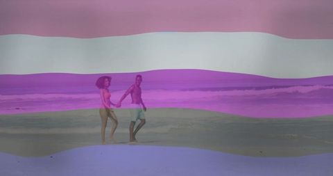 Couple Holding Hands Walking on Vibrant Beach