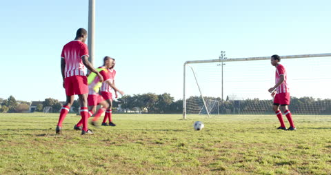 Soccer Players Practicing on Field Showing Teamwork