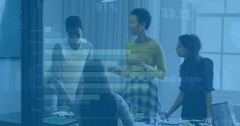 Leading women conducting strategy meeting with data charts overlay in modern glass office