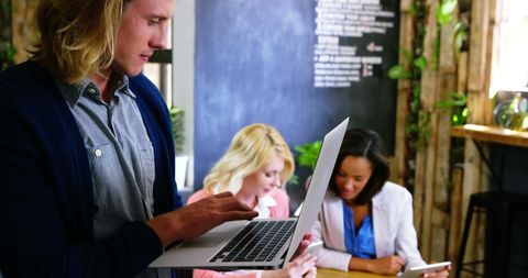 Young professionals collaborating in cozy coffee shop