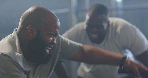 African men training together on cable machine showing strength motivation and camaraderie