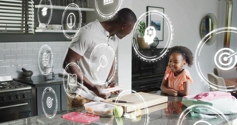 Father and daughter preparing lunch in modern kitchen with AR tech overlays
