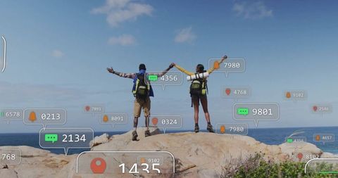 Couple Exploring Coastal Cliff With Digital Overlay Displays