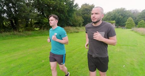 Two Men Jogging in Park Embrasing Fitness Lifestyle