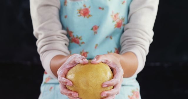 Person Holding Dough in Hands While Baking with Floral Apron - Download Free Stock Images Pikwizard.com