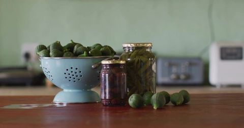 Fresh green figs with jars for rustic kitchen decor