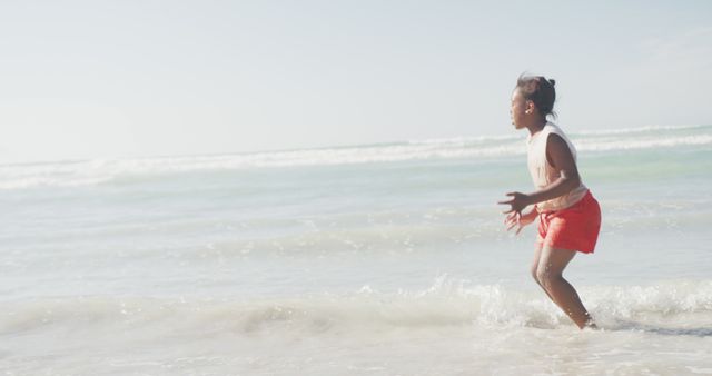 Excited Child Playing in Waves on Sunny Beach - Download Free Stock Images Pikwizard.com