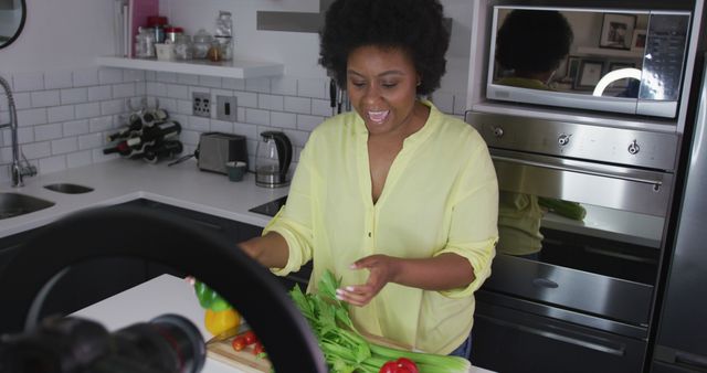 Happy Woman Cooking and Preparing Fresh Vegetables in Modern Kitchen - Download Free Stock Images Pikwizard.com