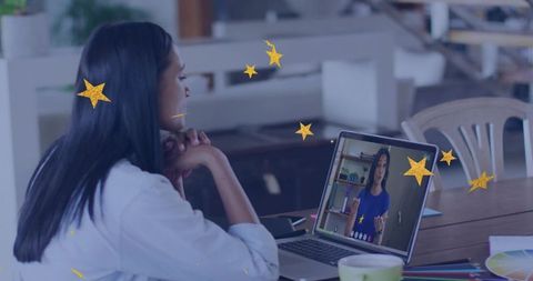 Woman Engaging in Virtual Meeting at Modern Office Desk
