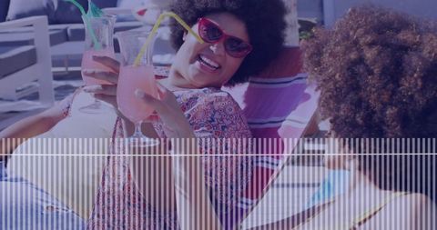 Mother and Daughter Relaxing by Pool With Colorful Mocktails