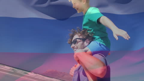 Happy Father and Son with Russian Flag Overlay at Beach