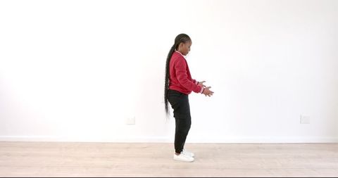 Young Girl Stretching in Red Sweater for Fitness and Flexibility
