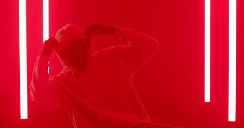 Man in White Hoodie with Neon Red Lighting