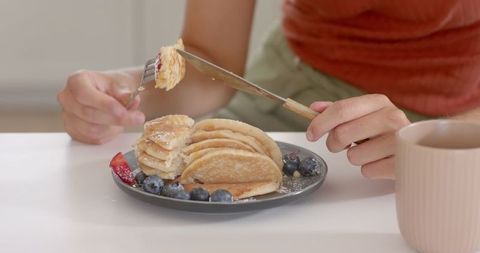 Cozy Breakfast Scene with Pancakes, Berries, Pink Mug