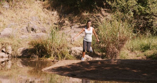 Woman jogging in the countryside on a sunny day - Download Free Stock Photos Pikwizard.com