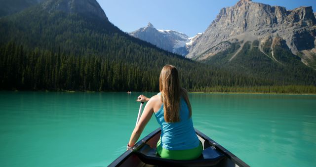 Woman Canoeing on Turquoise Lake with Mountain Backdrop - Download Free Stock Images Pikwizard.com