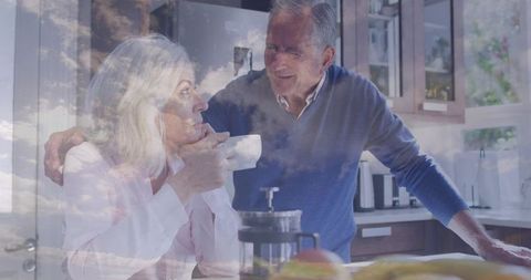 Sunlit double exposure senior couple sharing morning coffee in cozy kitchen