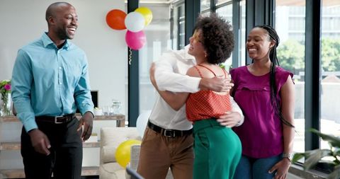 Celebratory Office Embrace with Diverse Team
