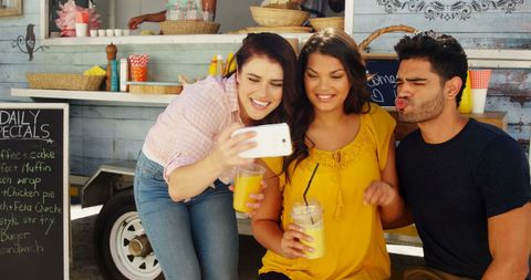 Young Adults Taking Selfie at Casual Outdoor Eatery - Download Free Stock Images Pikwizard.com