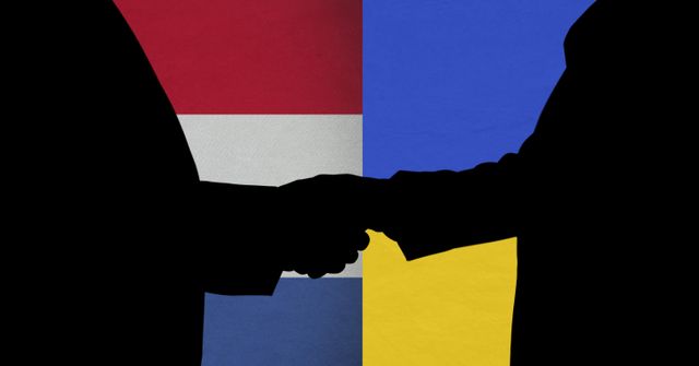 Silhouette of two men shaking hands against ukraine and netherlands flag background. international relations concept