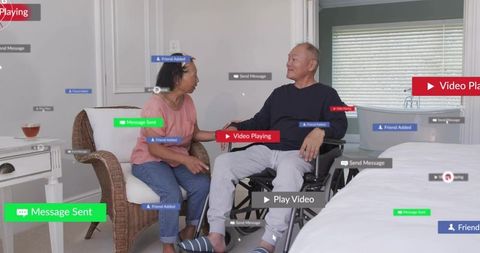 Adult son talking with elderly mother in bedroom with wheelchair and ar interface overlays