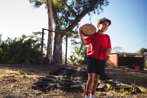Child enjoying playful outdoor adventure on tire path