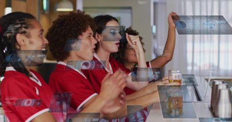 Cheering sports fans at bar counter holding beers with holographic interface overlays