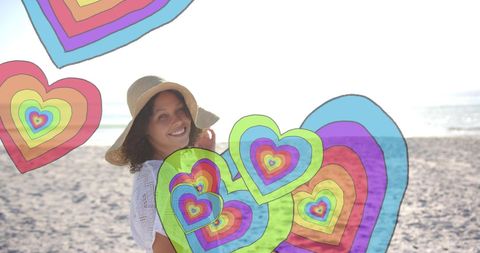 Smiling Woman Surrounded by Vibrant Hearts on Sunny Beach