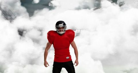 Confident American Football Player in Red Jersey on Foggy Field