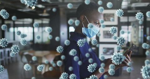 Woman in mask using smartphone surrounded by covid-19 representations