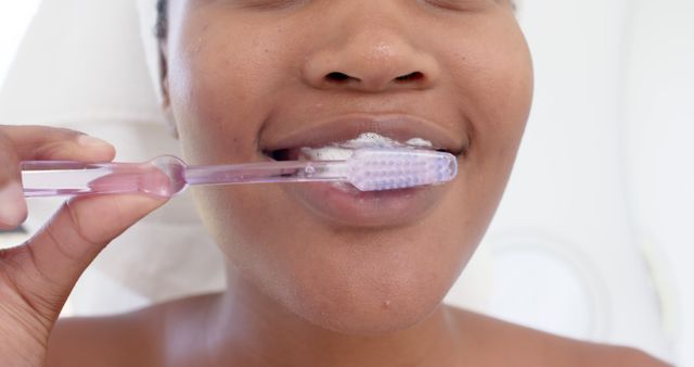 Close-Up of Woman Brushing Teeth with Transparent Toothbrush - Download Free Stock Images Pikwizard.com