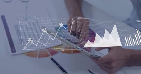 Business professional analyzing interactive tablet with floating data graphs and charts