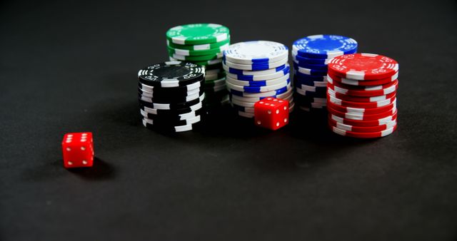 Pairs of dice and casino chips on poker table in casino 