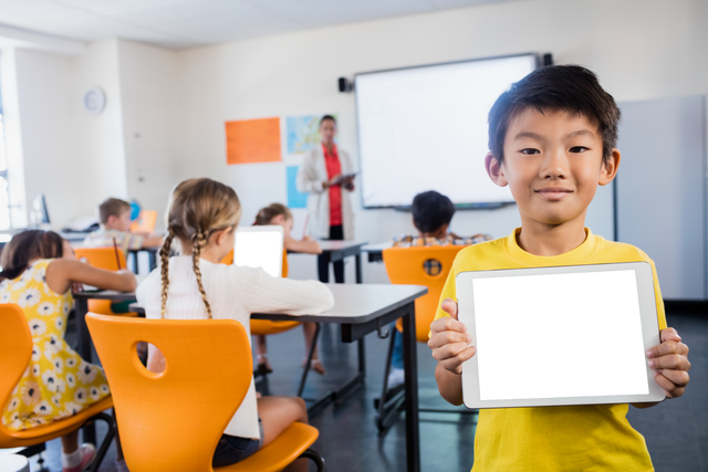 Transparent Tech Savvy Asian Schoolboy Holding Tablet in Classroom - Download Free Stock Videos Pikwizard.com