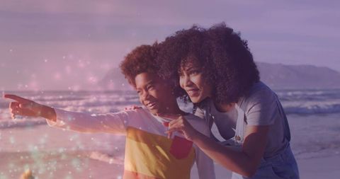 Mother and son exploring sunset beach with exuberance