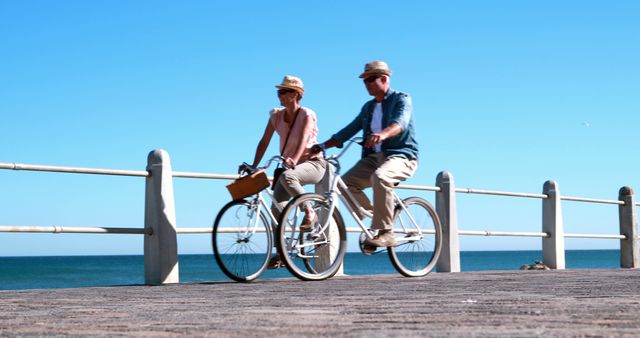 Couple Cycling On Boardwalk By The Ocean - Download Free Stock Images Pikwizard.com