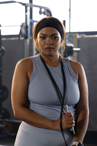 African american woman holding jump rope standing strong after intense cardio session