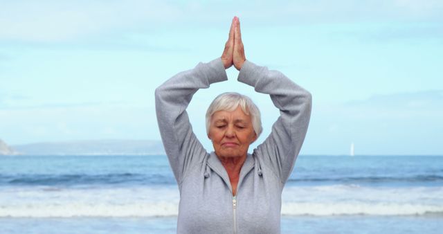 Senior Woman Practicing Yoga on Beach with Eyes Closed - Download Free Stock Images Pikwizard.com
