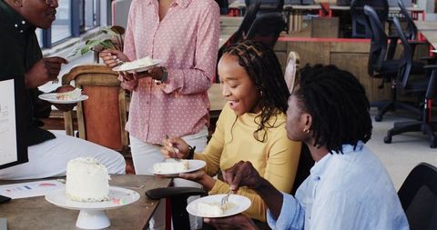 Colleagues Enjoying Cake During Office Break Meeting