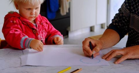 Father Guiding Daughter in Drawing Activity in Cozy Kitchen - Download Free Stock Images Pikwizard.com