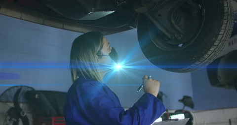 Mechanic Diagnosing Car Issues in Workshop with Tech Overlay