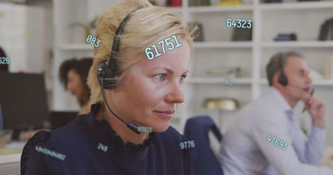 Customer service agent wearing headset handling calls with data overlays in office