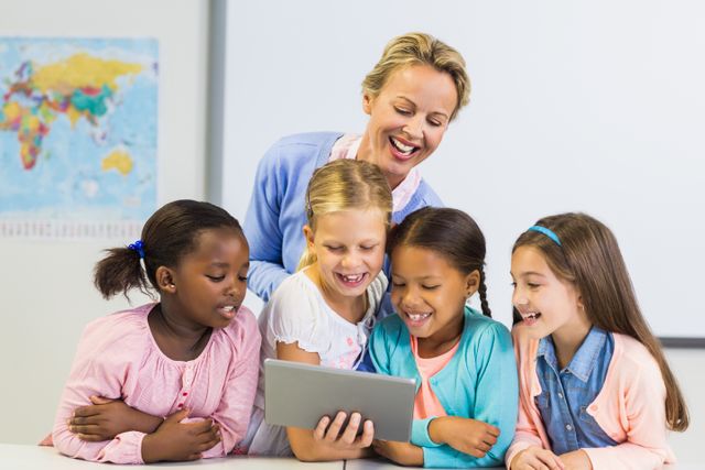 Teacher and Diverse Students Using Tablet in Classroom - Download Free Stock Photos Pikwizard.com