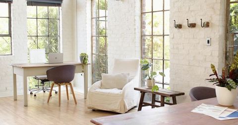 Minimalist Loft Office with White Armchair and Greenery